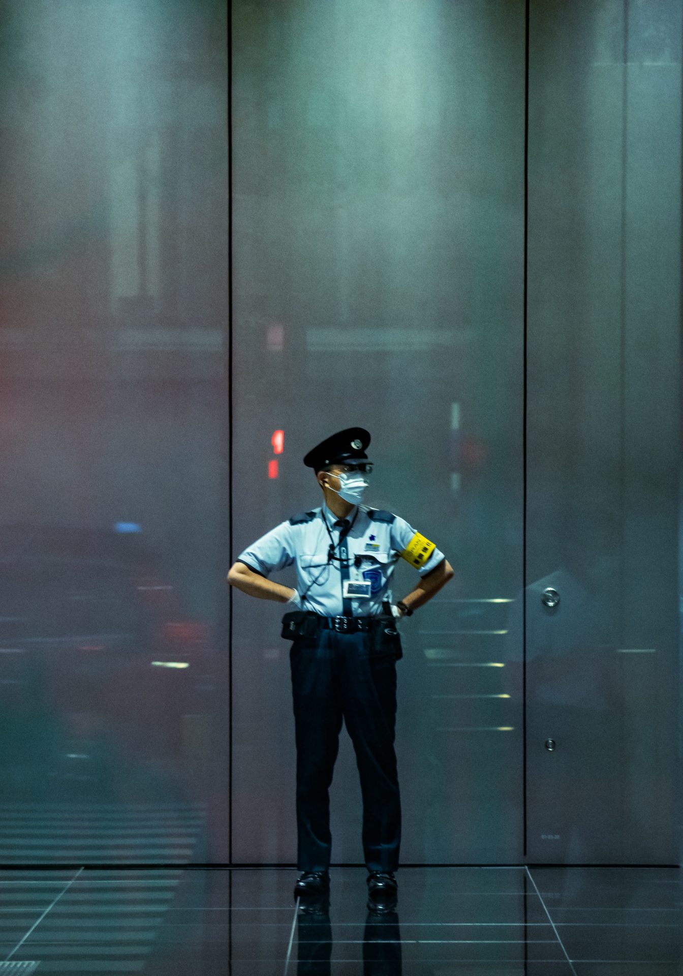 posing security guard with the reflections on the big glass windows