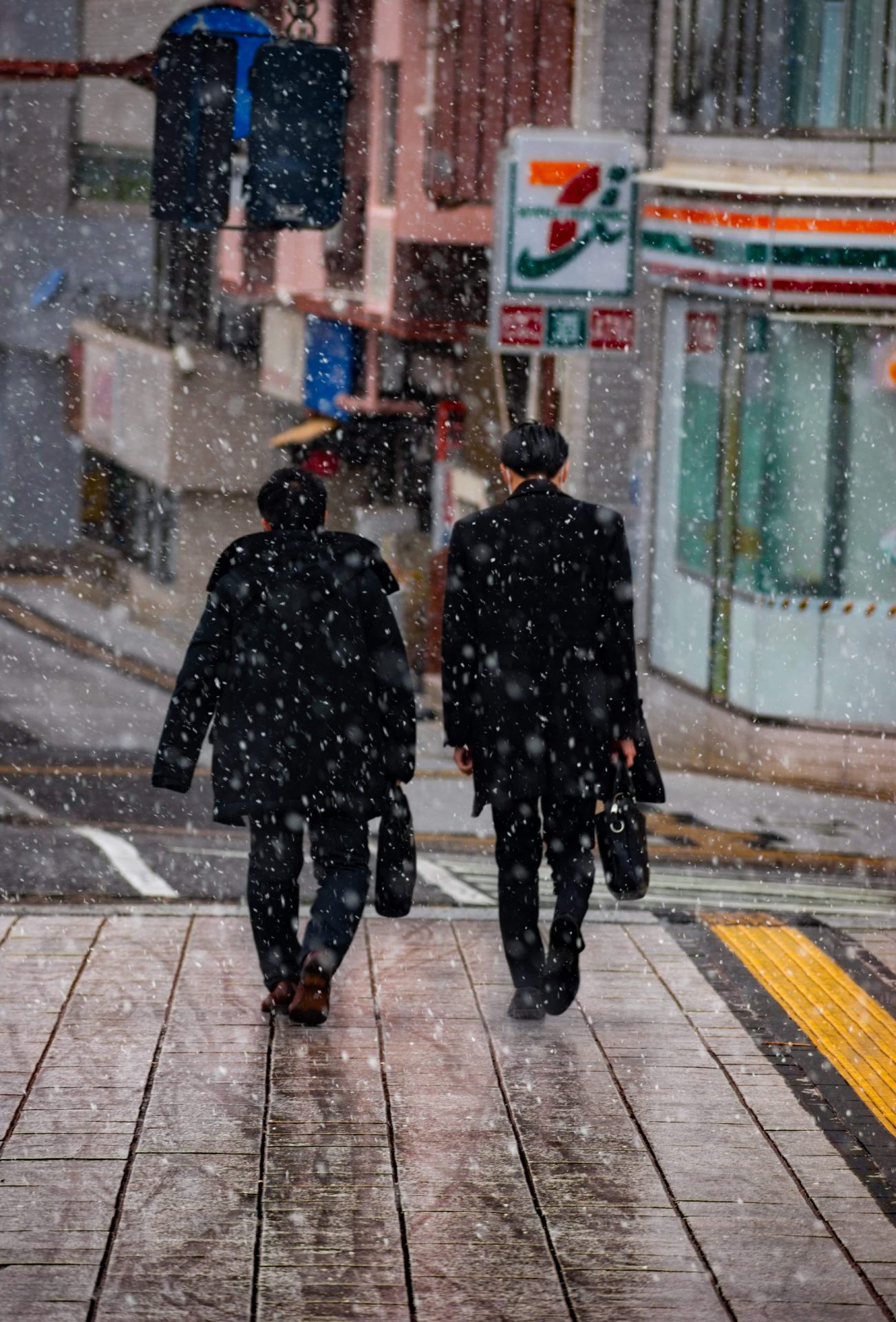 businessman walkin home in the snowfall in Japan