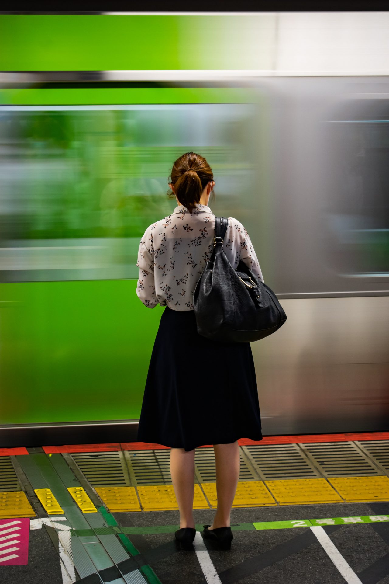 Woman waiting for the train in Tokyo