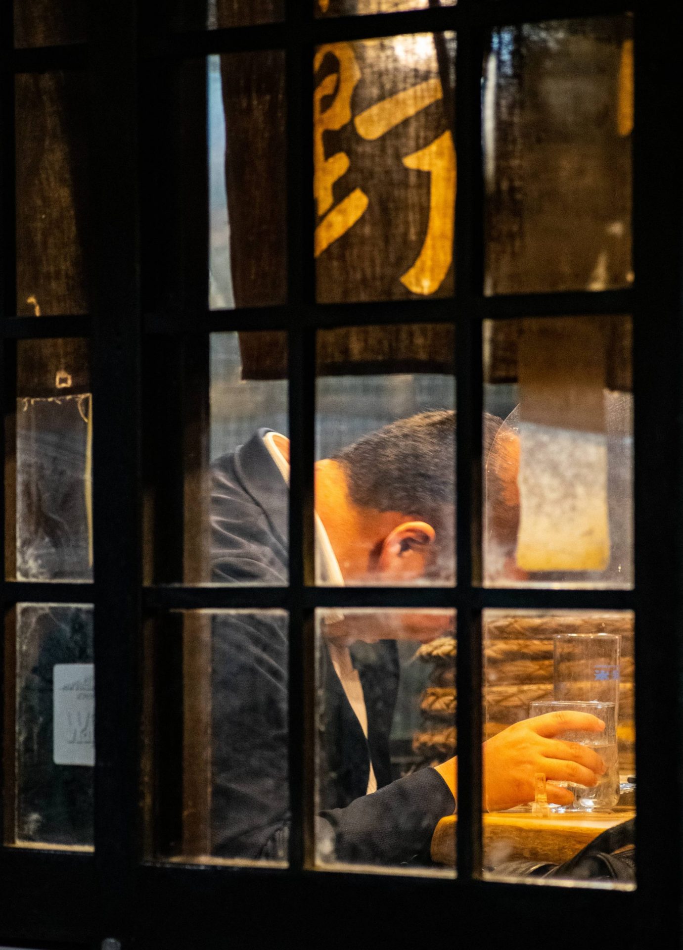 Businessman drinking in a small bar