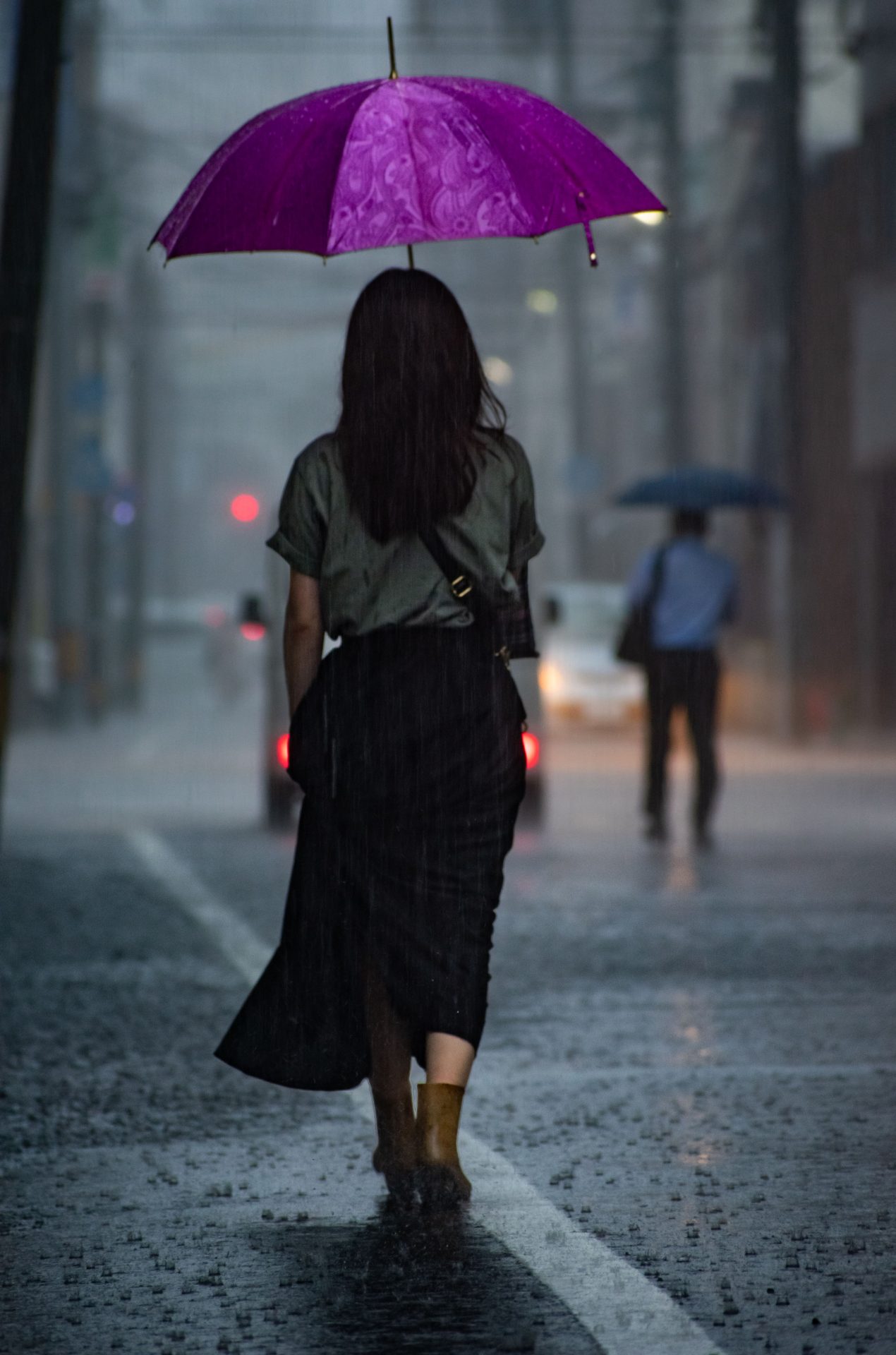 A women with purple umbrella walking in a heavy rainfaill, Hiroshima