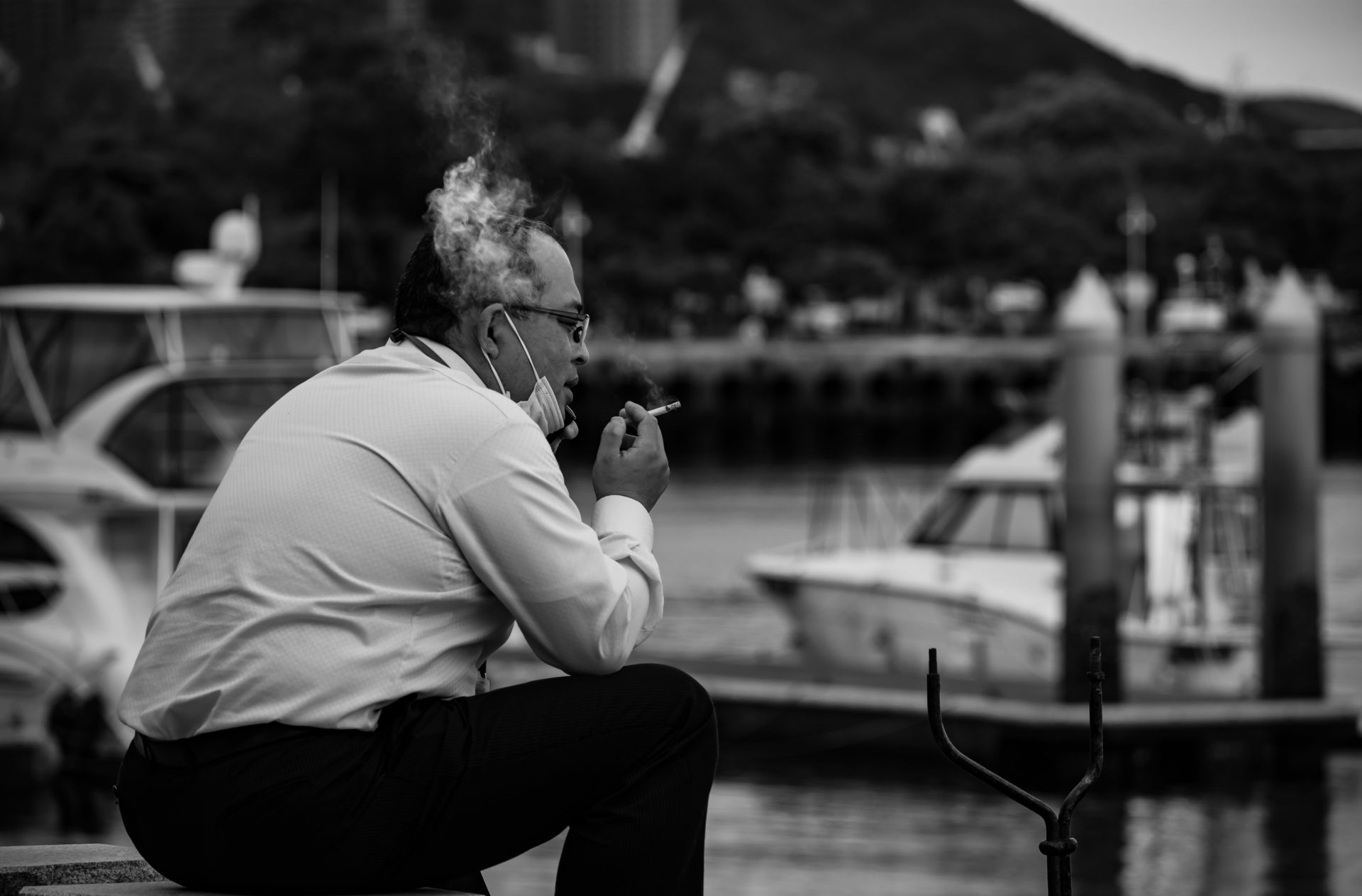 Japanese man taking a smoke break at the port of Nagasaki