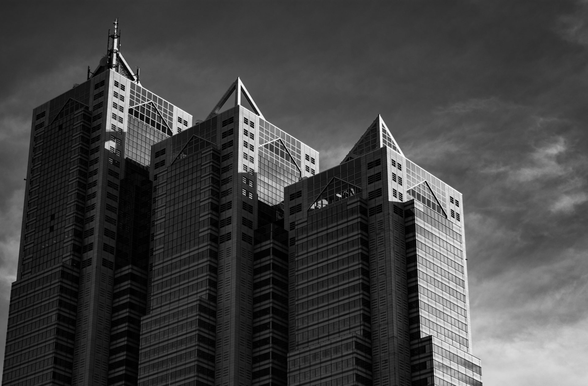 three same style building in the harsh sunlight, black and white photography