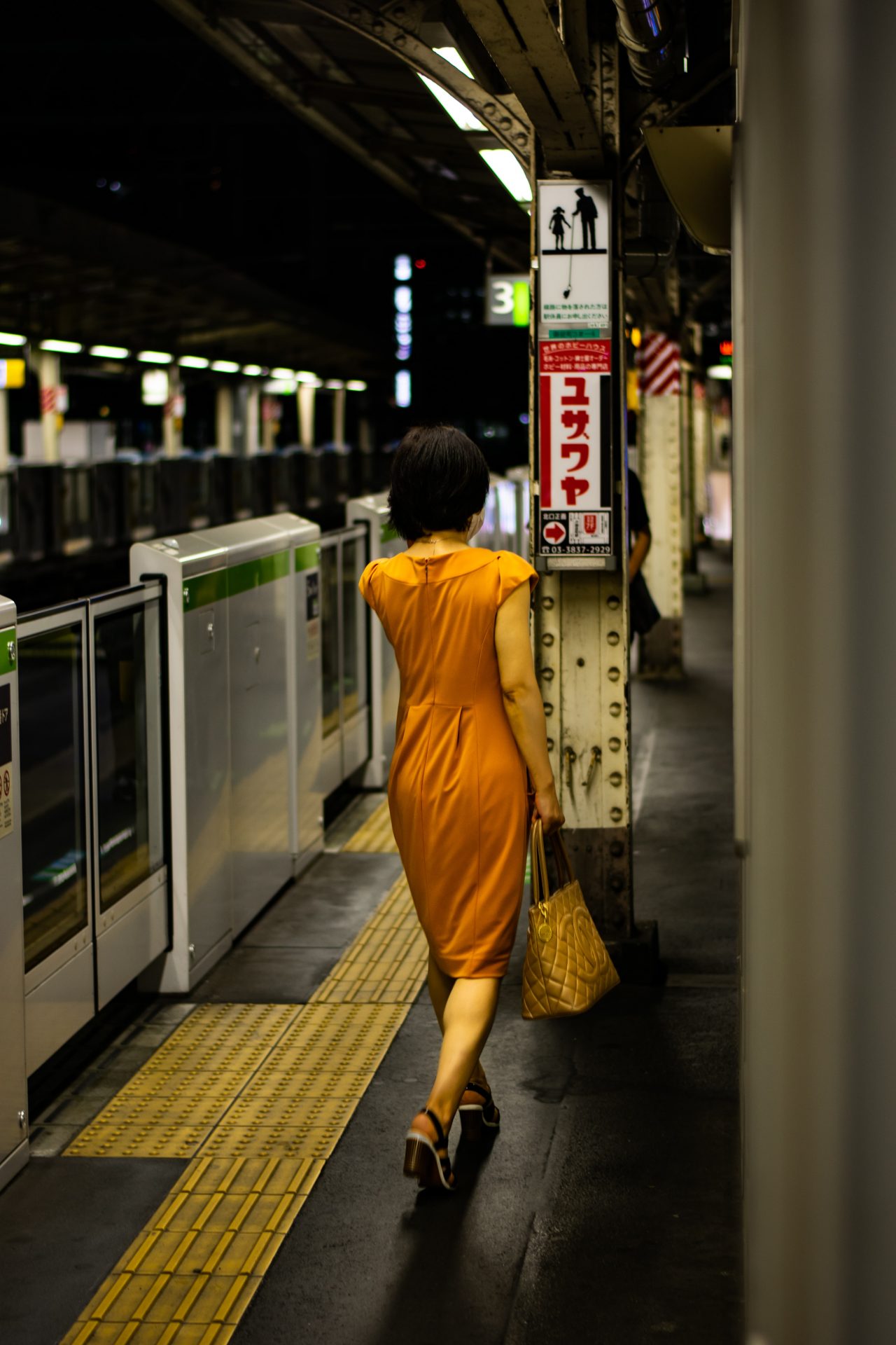 train station photography session with a women in orange dress